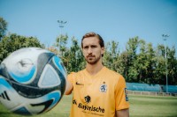 Spieler des TSV 1860 Marco Hiller steht auf dem Spielfeld und hält einen Ball in die Kamera