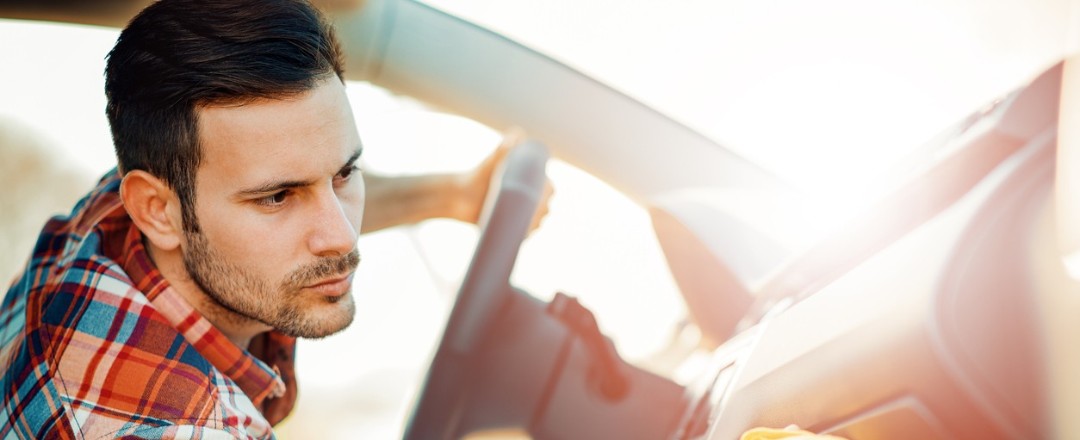 Ein Mann säubert die Beifahrerseite eines Autos Ein Mann säubert die Beifahrerseite eines Autos