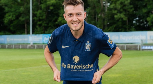 Fußballspieler im blauen Trikot von 1860 München auf einem Fußballfeld. Fußballspieler im blauen Trikot von 1860 München auf einem Fußballfeld.