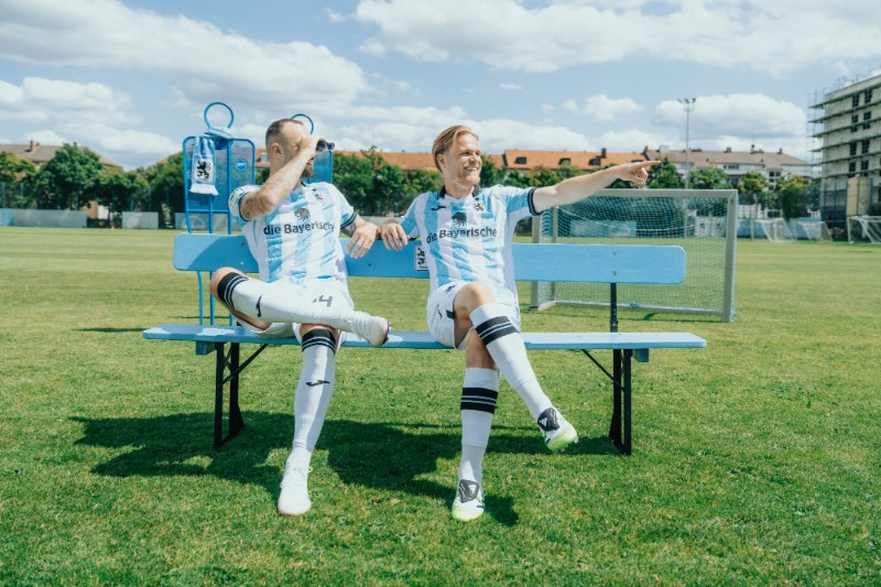 Zwei Spieler des TSV 1860 sitzen auf einer Bank und schauen in die Ferne.