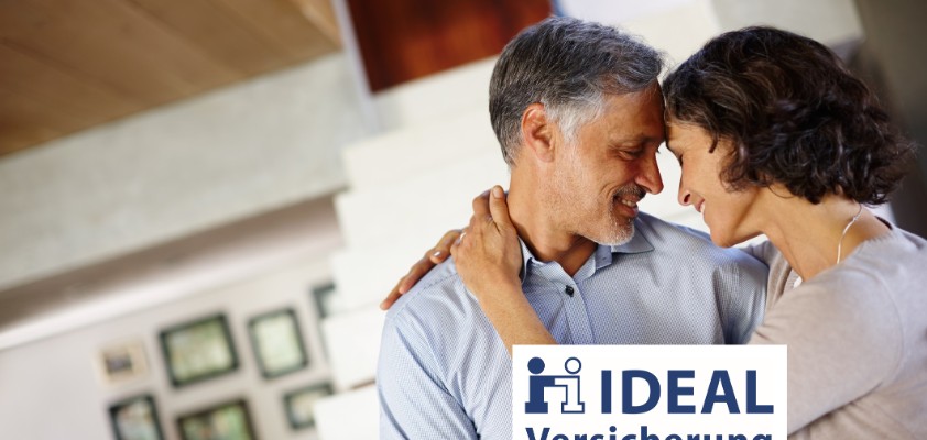 Ein Mann und eine Frau schauen sich vertraut an und berühren sich an Armen und Stirn. Unten rechts im Bild ist das Logo des Versicherers Ideal zu sehen.