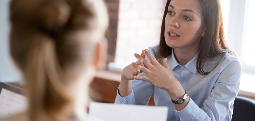 Eine Business-Frau führt ein Gespräch mit Kunden.  