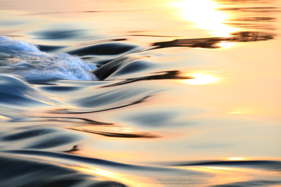Wasser mit leichtem Wellengang im Sonnenuntergang Wasser mit leichtem Wellengang im Sonnenuntergang